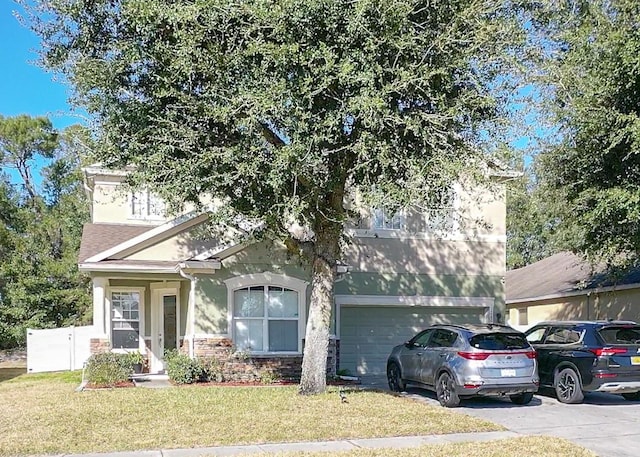 view of front facade with a garage and a front yard