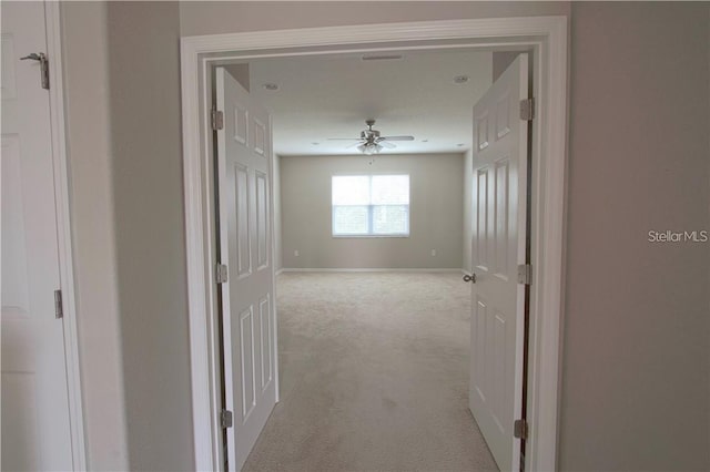 hallway with light colored carpet