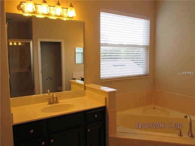 bathroom with vanity, toilet, and a bathtub