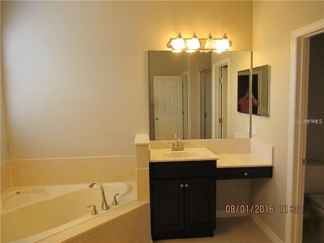 bathroom featuring vanity, tile patterned flooring, a relaxing tiled tub, and toilet