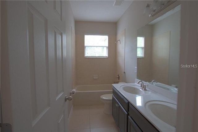 full bathroom with tiled shower / bath, tile patterned floors, toilet, and vanity