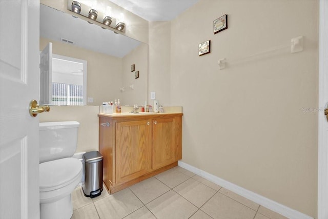 bathroom featuring vanity, tile patterned floors, and toilet