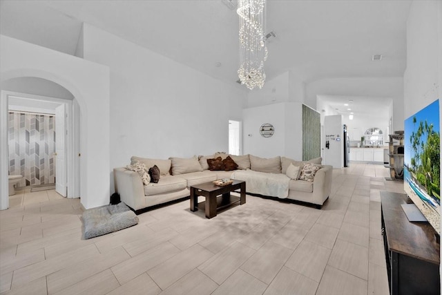 living room featuring a high ceiling and a notable chandelier