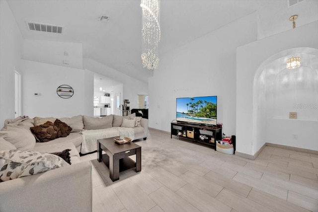 living room with a high ceiling and a chandelier