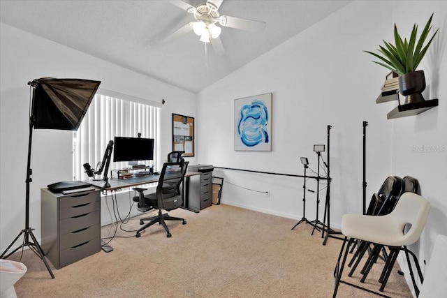 office area featuring ceiling fan, light colored carpet, lofted ceiling, and a textured ceiling