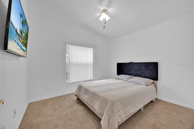 bedroom featuring ceiling fan, light colored carpet, and lofted ceiling