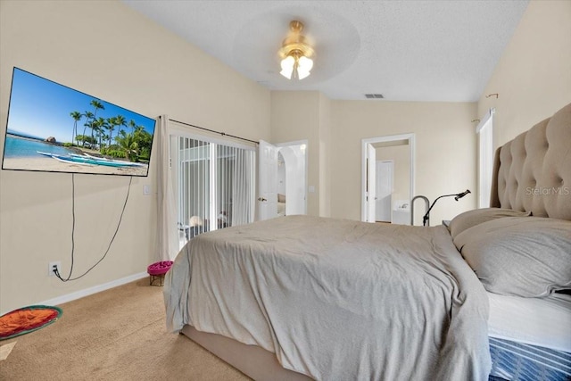 bedroom featuring light colored carpet, access to exterior, vaulted ceiling, and a textured ceiling