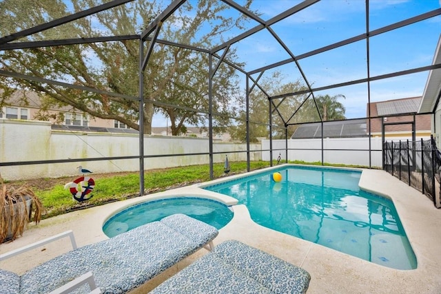 view of swimming pool with glass enclosure and a patio area