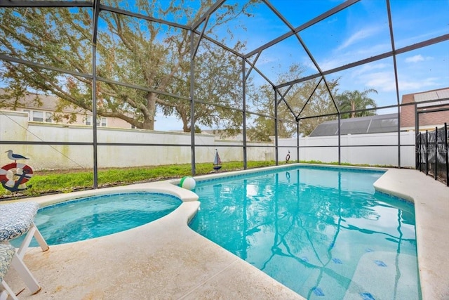 view of pool with a patio area and glass enclosure