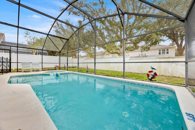 view of swimming pool featuring glass enclosure