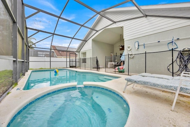 view of swimming pool with a patio area, ceiling fan, and glass enclosure