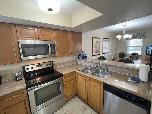 kitchen featuring sink, light tile patterned floors, an inviting chandelier, stainless steel appliances, and kitchen peninsula