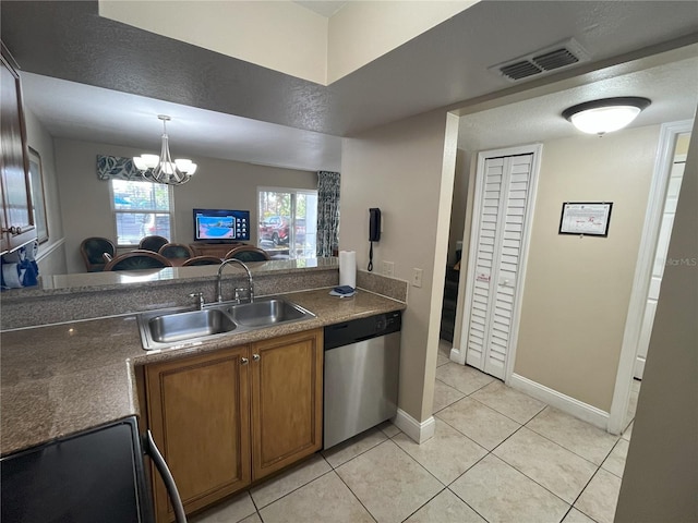 kitchen with an inviting chandelier, sink, light tile patterned floors, and stainless steel dishwasher