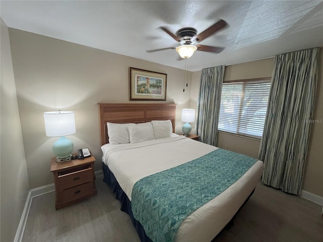 bedroom with wood-type flooring and ceiling fan