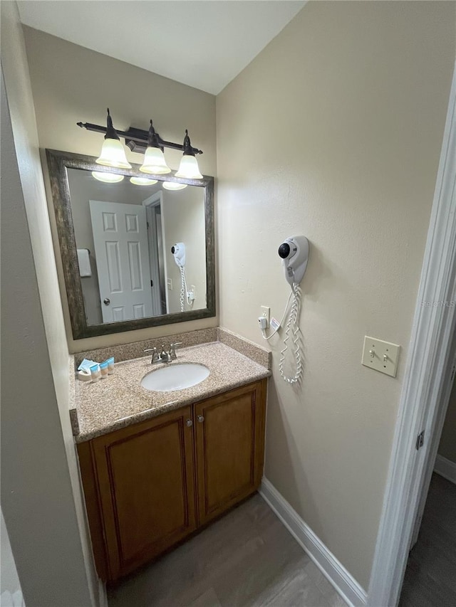 bathroom with vanity and hardwood / wood-style floors