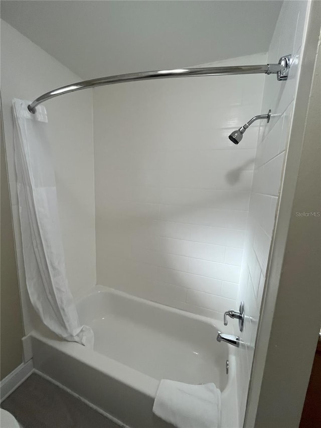 bathroom featuring shower / bathtub combination with curtain