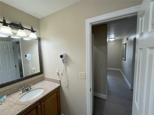 bathroom with vanity and wood-type flooring