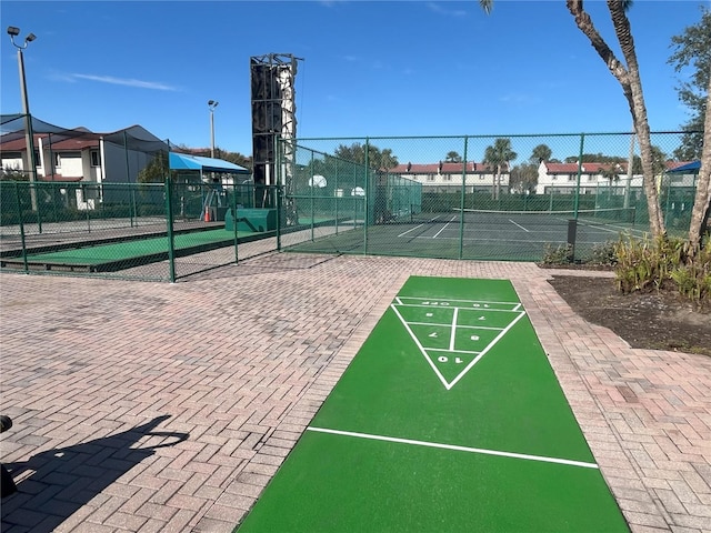 surrounding community with tennis court