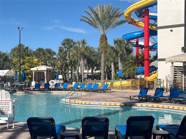 view of swimming pool with a water slide