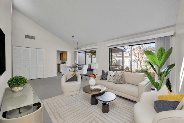 living room with high vaulted ceiling