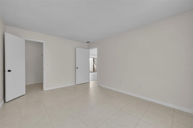 tiled spare room with a textured ceiling