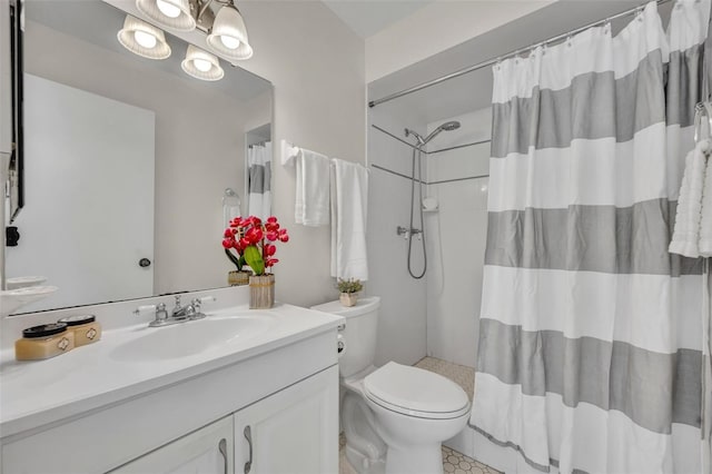 bathroom featuring vanity, curtained shower, and toilet