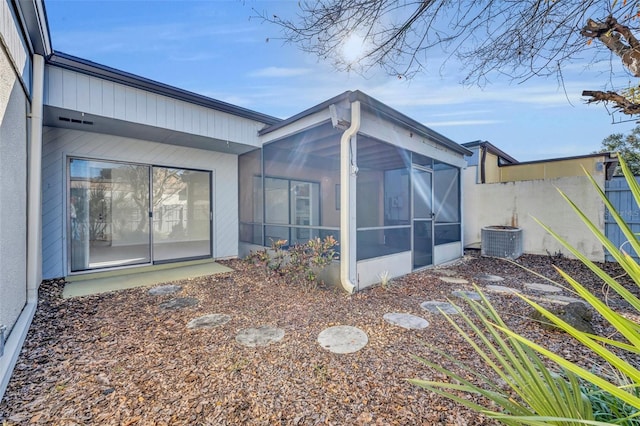 back of property featuring cooling unit and a sunroom