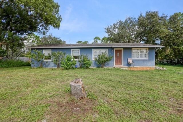 ranch-style house featuring a front lawn