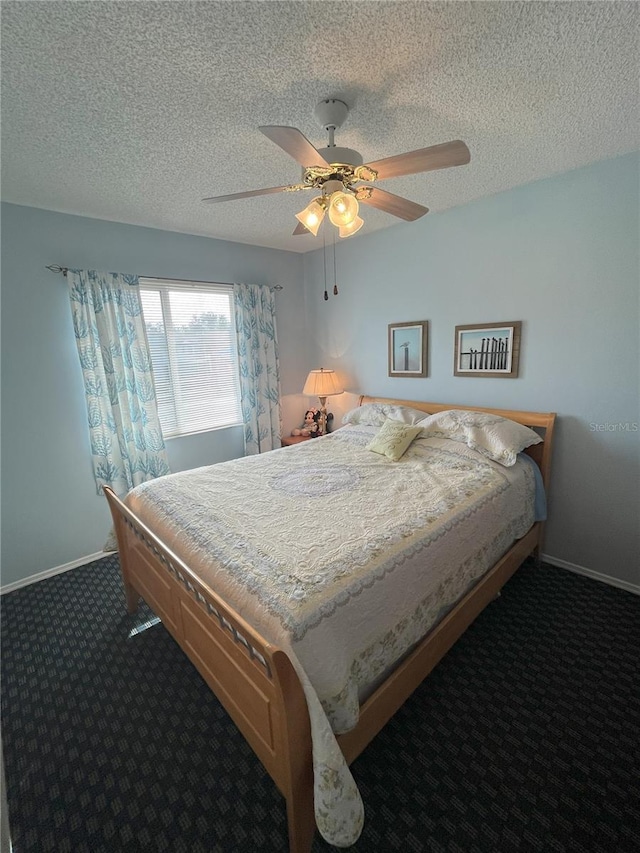 carpeted bedroom with ceiling fan and a textured ceiling