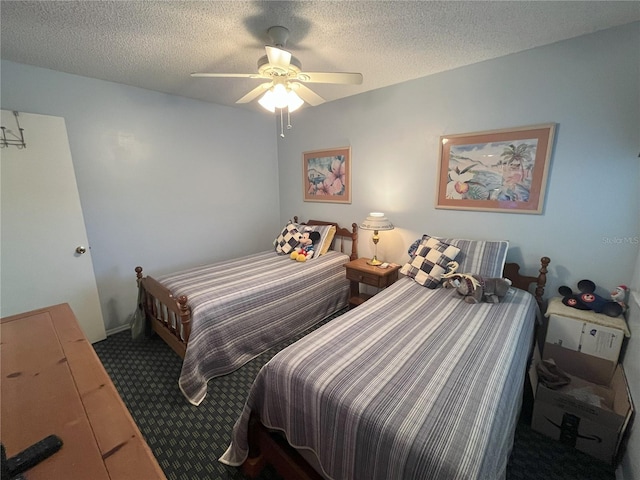 carpeted bedroom featuring ceiling fan and a textured ceiling