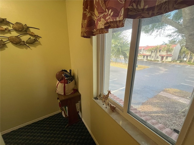 doorway to outside featuring carpet