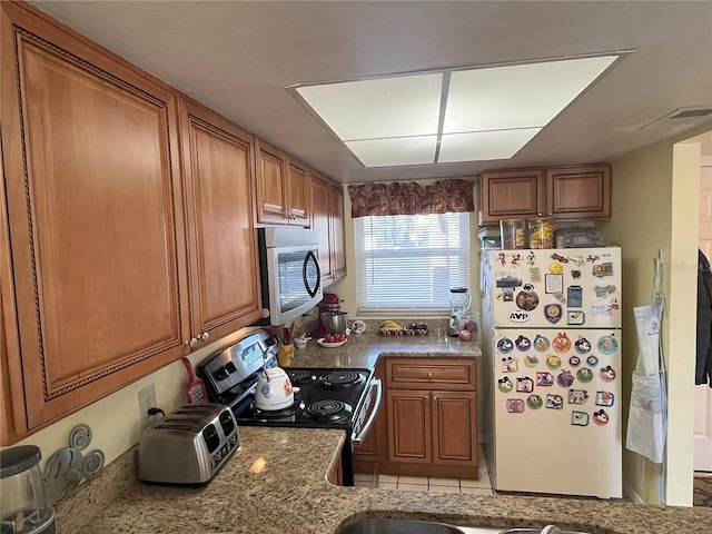 kitchen featuring light stone countertops and appliances with stainless steel finishes