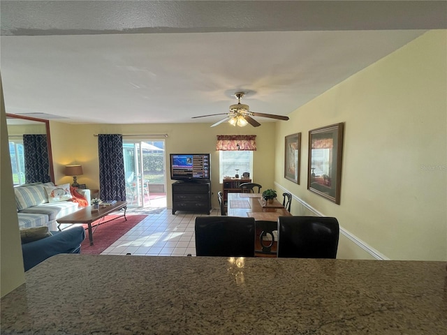 tiled dining space featuring ceiling fan