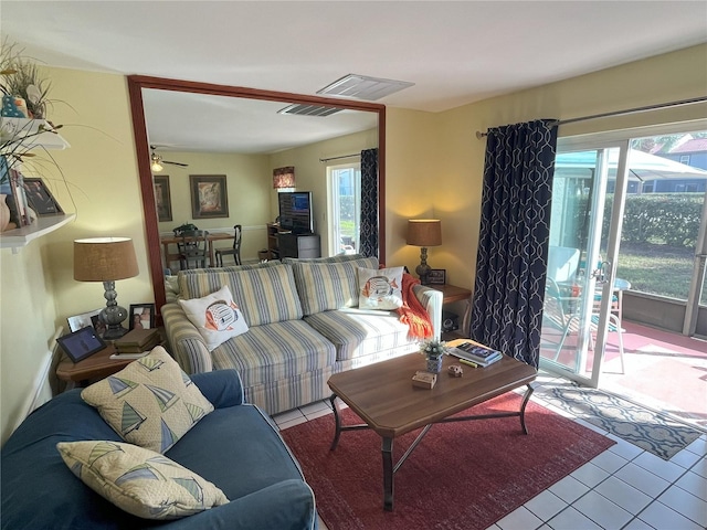 living room featuring ceiling fan, plenty of natural light, and light tile patterned floors