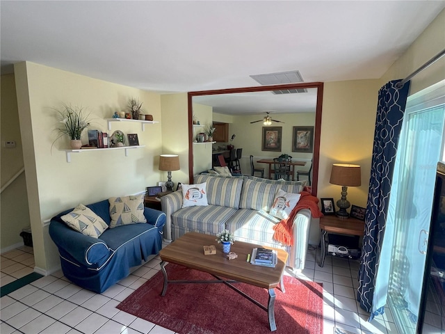 tiled living room featuring ceiling fan