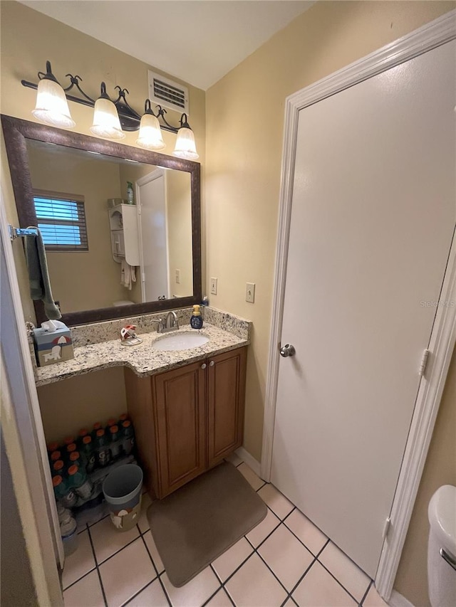 bathroom with vanity, tile patterned flooring, and toilet