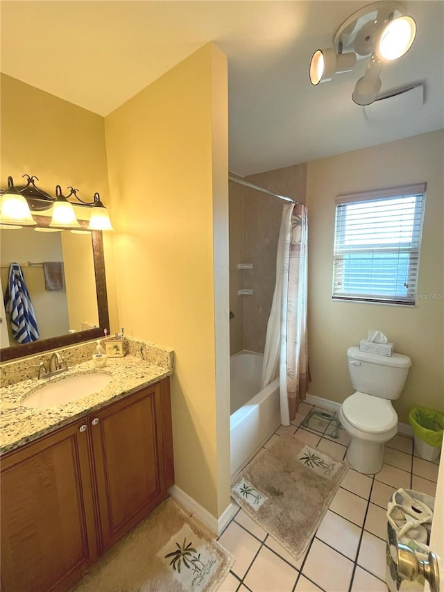 bathroom featuring shower / tub combo with curtain, baseboards, vanity, and tile patterned floors