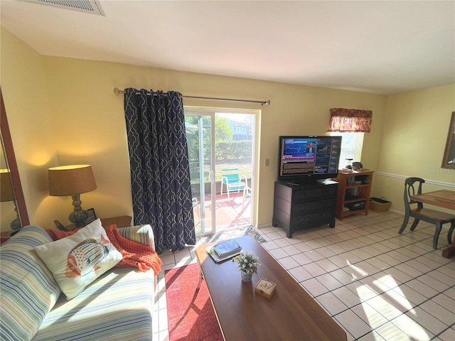 living room featuring visible vents and light tile patterned flooring