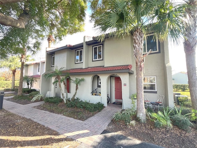 view of front of house with a tile roof and stucco siding