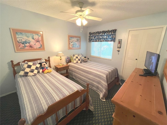 bedroom featuring a ceiling fan, baseboards, dark carpet, and a textured ceiling