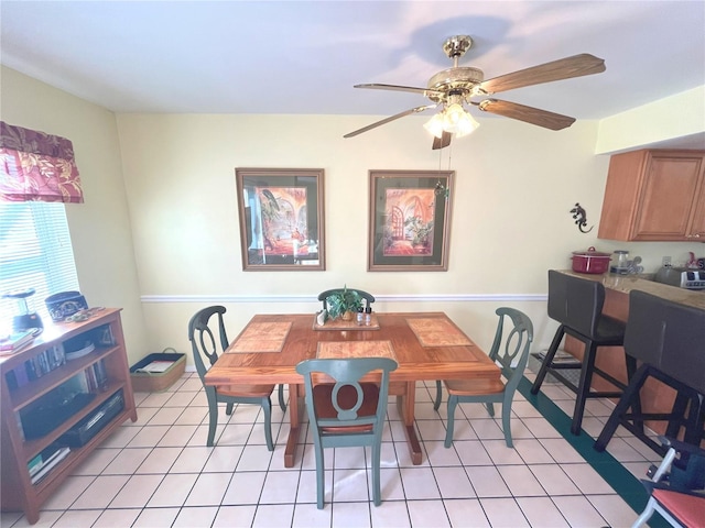 dining area with light tile patterned floors and ceiling fan