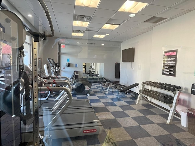 gym featuring a paneled ceiling and visible vents