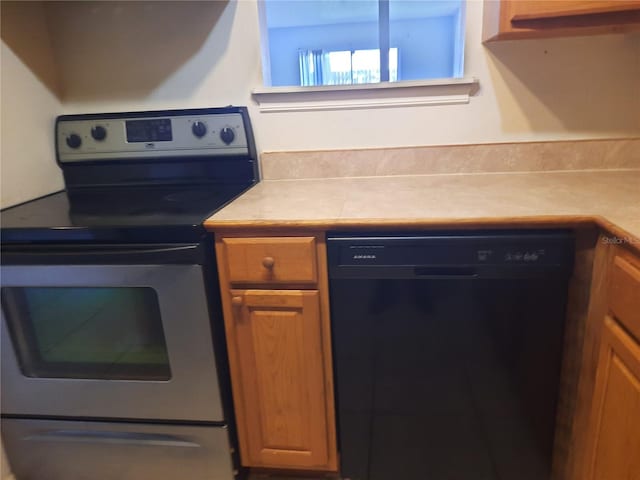 kitchen with electric stove and black dishwasher