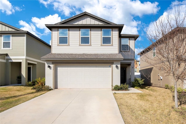 view of front of property with a garage and a front lawn