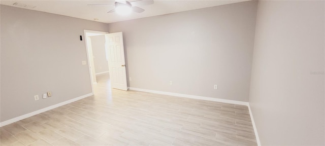 empty room with ceiling fan and light hardwood / wood-style floors