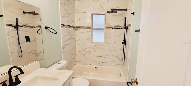 full bathroom featuring tiled shower / bath, vanity, and toilet