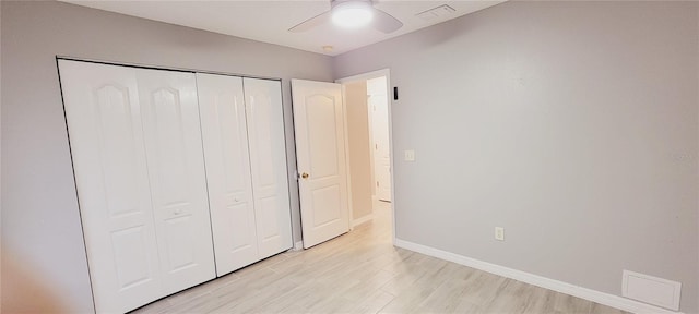 unfurnished bedroom with ceiling fan, a closet, and light hardwood / wood-style flooring