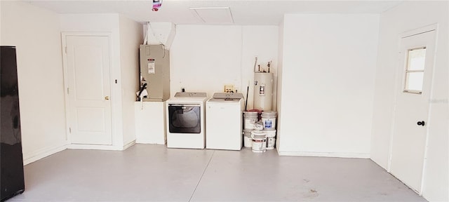 laundry room featuring washing machine and clothes dryer, water heater, and heating unit