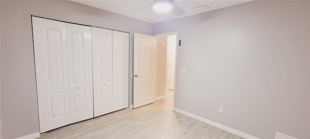 unfurnished bedroom featuring light hardwood / wood-style floors, a closet, and ceiling fan