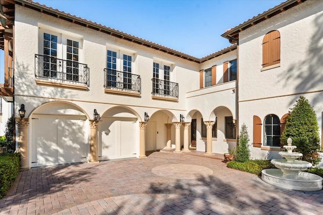 view of front of property with a garage and a balcony